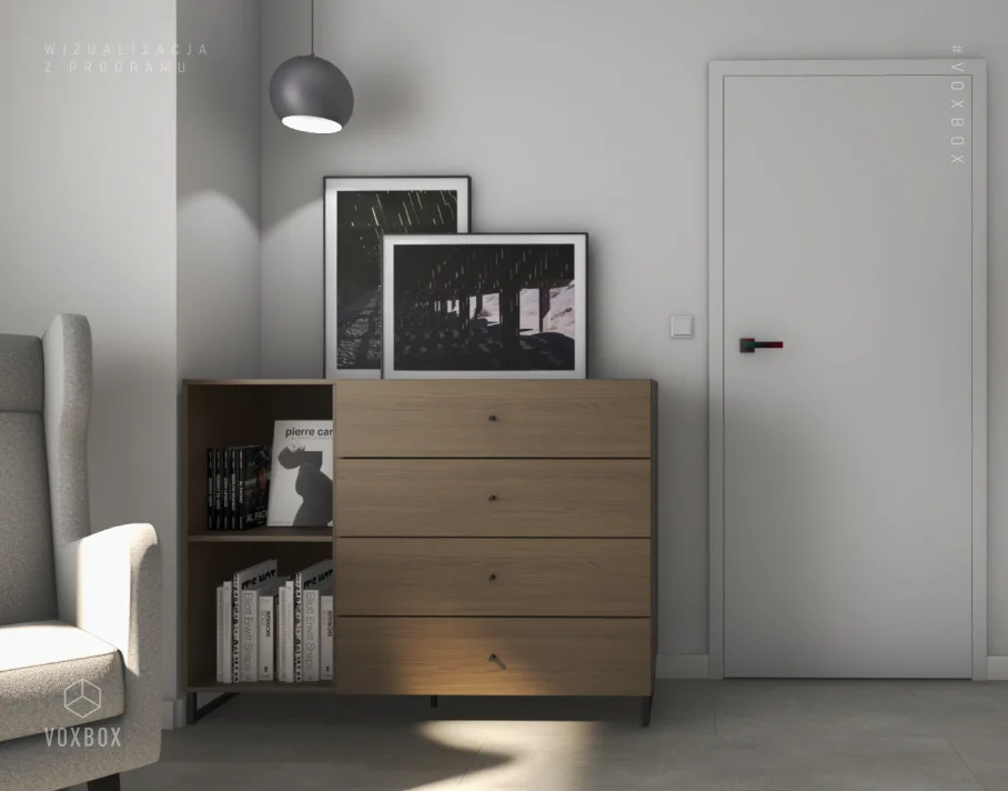 Jasna komoda i fotel uszak w minimalistycznie urządzonym gabinecie.